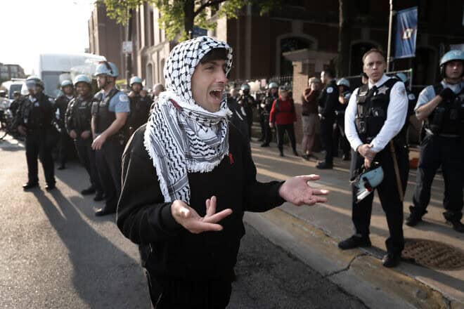 Chicago police guard an entrance to campus while workers remove a pro-Palestinian encampment at DePaul University, in the Lincoln Park neighborhood of the city, on May 16, 2024. Photo by Scott Olson/Getty Images.