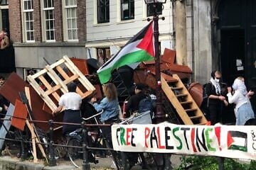 Demonstrators reinforce a barricade at an anti-Israel tent encampment at the University of Amsterdam, six months to the day after a violent citywide attack against Maccabi Tel Aviv soccer fans, on May 7, 2024. Credit: Umbrellafighter via Wikimedia Commons.