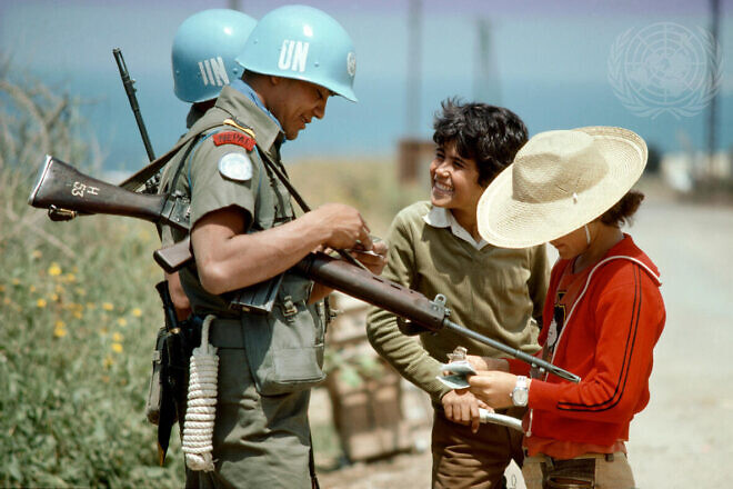Nepalese soldiers serving with UNIFIL chatting with two young Lebanese boys outside UNIFIL headquarters in Naqoura, April 27, 1978. Credit: John Isaac/U.N. Photo.