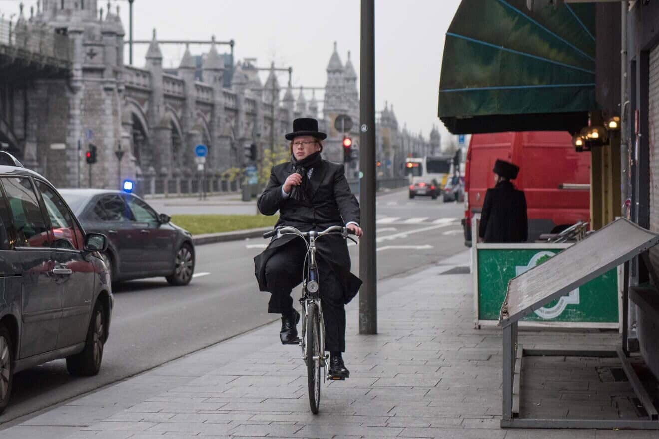 A Jewish man cycles through central Antwerp, Belgium, on March 24, 2016. Photo by Canaan Lidor.