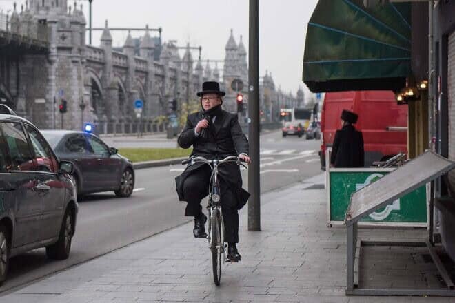 A Jewish man cycles through central Antwerp, Belgium, on March 24, 2016. Photo by Canaan Lidor.