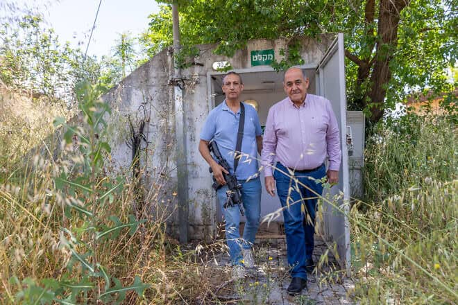 David Azulay, left, head of the Metula Regional Council, exits a bomb shelter with Shlomi Mayor Gabi Naaman, Metula, Israel, May 7, 2024. Photo by Yossi Aloni/Flash90.
