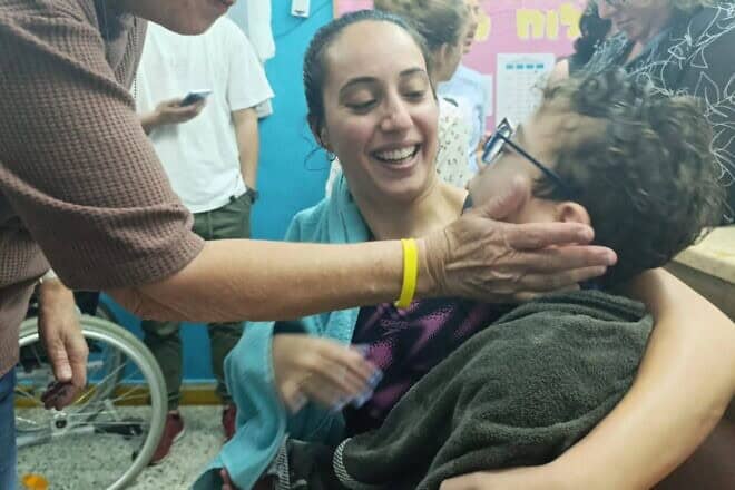 A volunteer at Beit Issie Shapiro checks on the welfare of a student and his teacher moments after a rocket siren rang out. Credit: Courtesy.