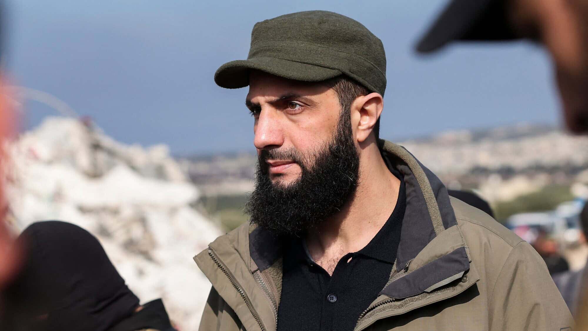 Hayat Tahrir al-Sham chief Abu Mohammad al-Julani checks the damage following an earthquake in Besnaya, in Syria's rebel-held northwestern Idlib Province at the border with Turkey, on Feb. 7, 2023. Photo by Omar Haj Kadour/AFP via Getty Images.