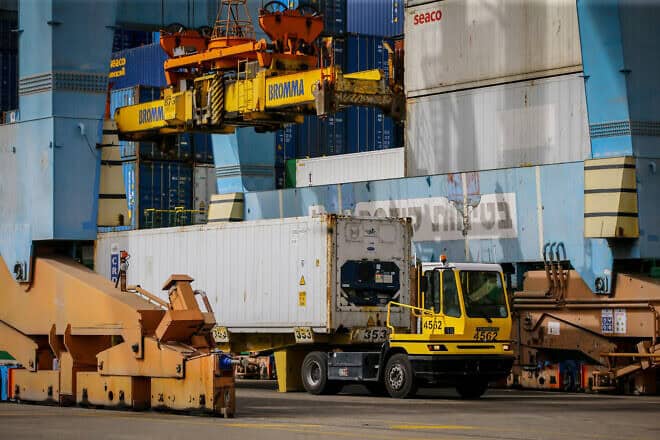 Workers unload a container with millions of eggs imported from Spain at Ashdod Port on April 5, 2020. Credit: Flash90.