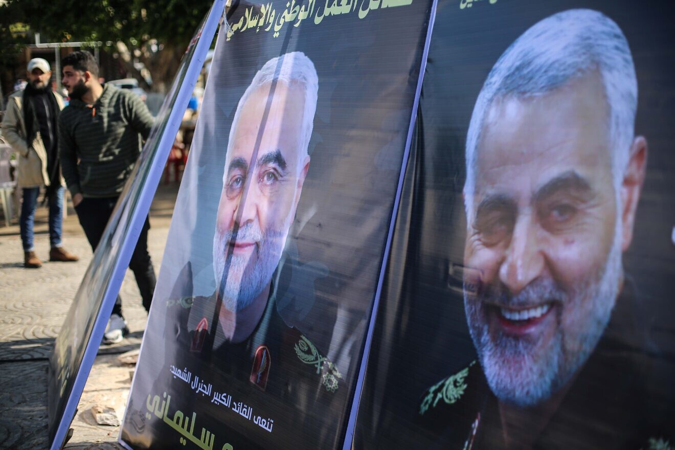Palestinians walk next to posters of Qassem Soleimani who was killed in a U.S. drone strike on Jan. 2, near a mourning tent in Gaza City on Jan. 4, 2020. Photo by Hassan Jedi/Flash90.