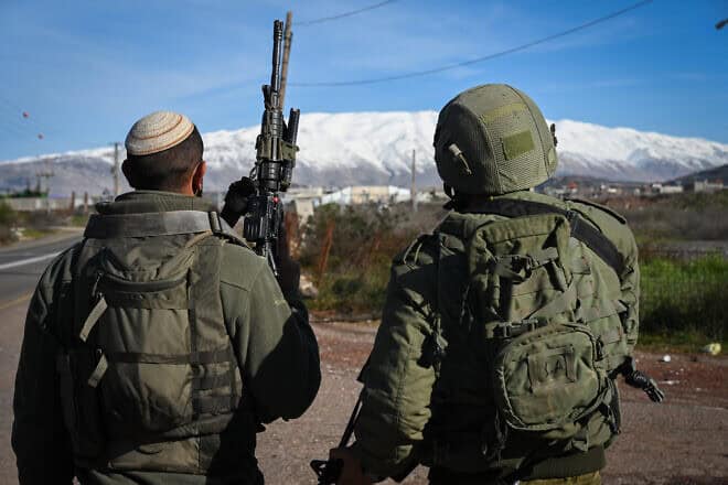 Israeli soldiers in the Golan Heights, northern Israel, with Mount Hermon in the background, Feb. 8, 2024. Photo by Michael Giladi/Flash90.