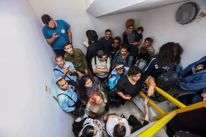 Israelis take cover inside a bomb shelter at Ben-Gurion International Airport as a siren alert is sounded, Oct. 1, 2024. Photo by Dor Pazuelo/Flash90.