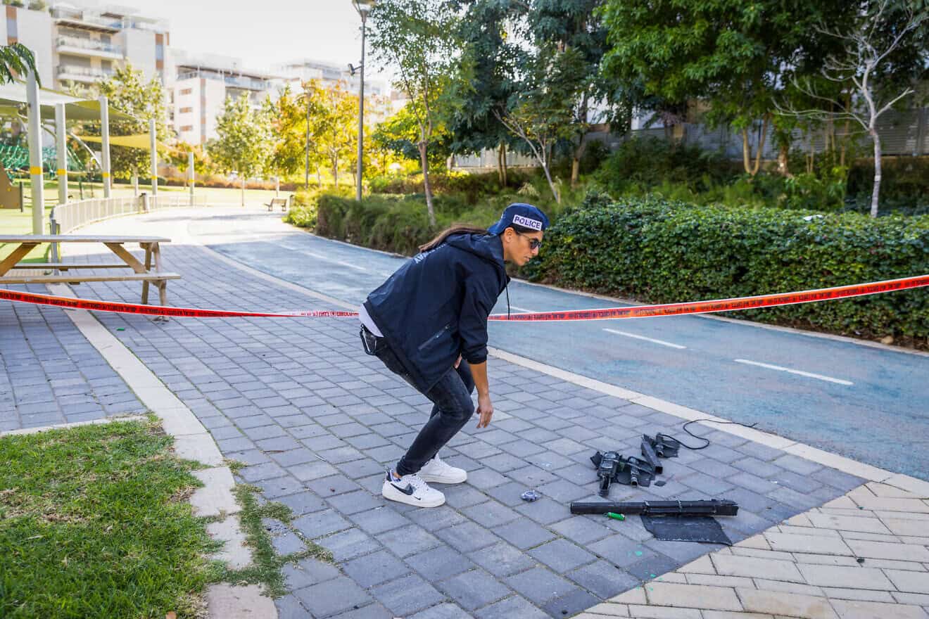 An Israeli policeman at the scene where a drone fired from Yemen hit a building in Yavne, Dec. 9, 2024. Photo by Liron Moldovan/Flash90.