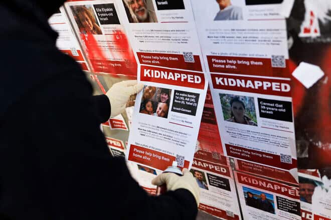 People replace posters of hostages taken captive by Hamas during the terror attack on Israel on October 7th after being ripped down in New York City, on Nov. 30, 2023. Photo by Michael M. Santiago via Getty Images.