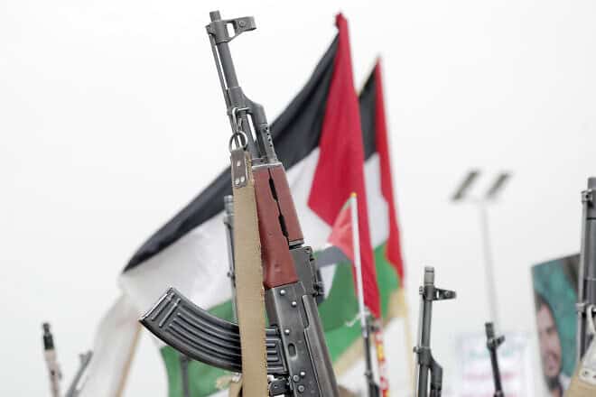 Yemenis brandish rifles and PLO flags during a demonstration against Israeli strikes in the country, July 26, 2024. Photo by Mohammed Hamoud/Getty Images.