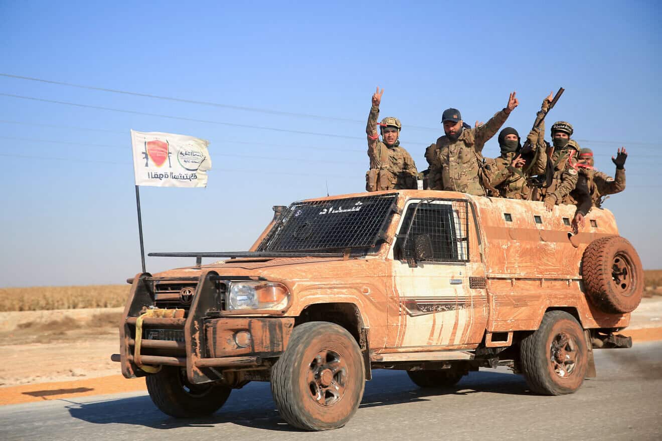 Syrian rebels in a military vehicle in the eastern part of Aleppo Province on Dec. 1, 2024. Photo by Aref Tammawi/AFP via Getty Images.