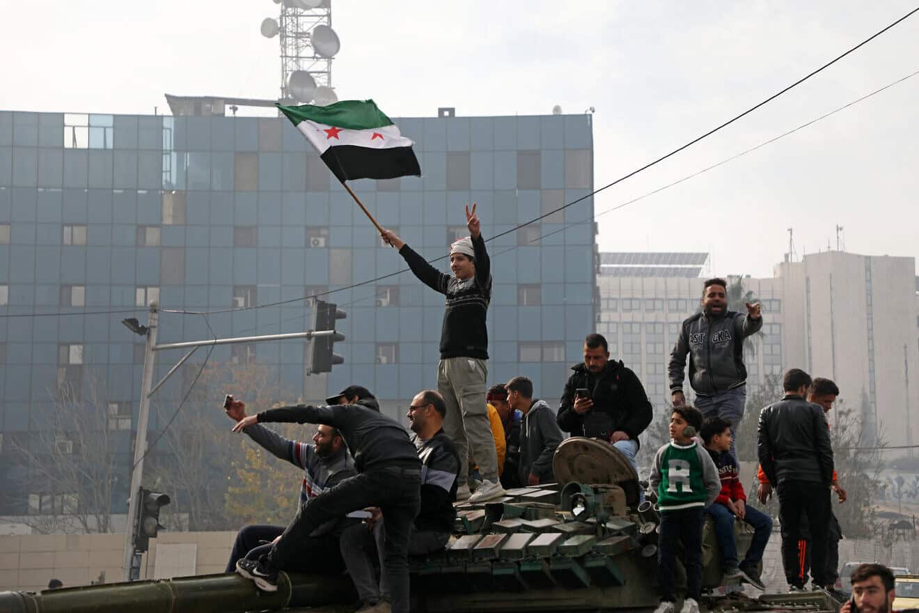 People react to the fall of Syrian regime in Umayyad Square on Dec. 8, 2024 in Damascus, Syria. Photo by Ali Haj Suleiman/Getty Images.