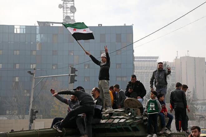 People react to the fall of Syrian regime in Umayyad Square on Dec. 8, 2024 in Damascus, Syria. Photo by Ali Haj Suleiman/Getty Images.