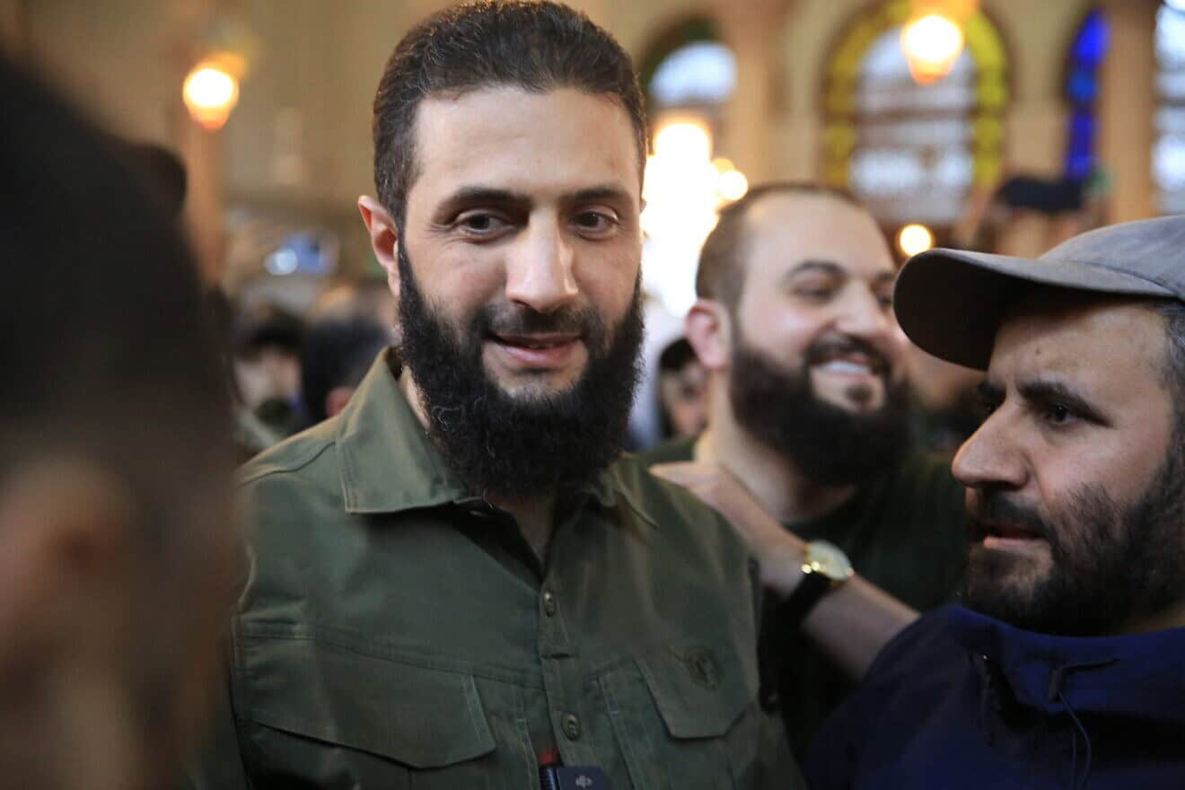 Supporters welcome the leader of Syria's Islamist Hayat Tahrir al-Sham (HTS) group that headed a lightning rebel offensive snatching Damascus from government control, Abu Mohammed al-Jolani (center), before his address at the capital's landmark Umayyad Mosque on Dec. 8, 2024. Photo by Aref Tammawi/AFP via Getty Images.