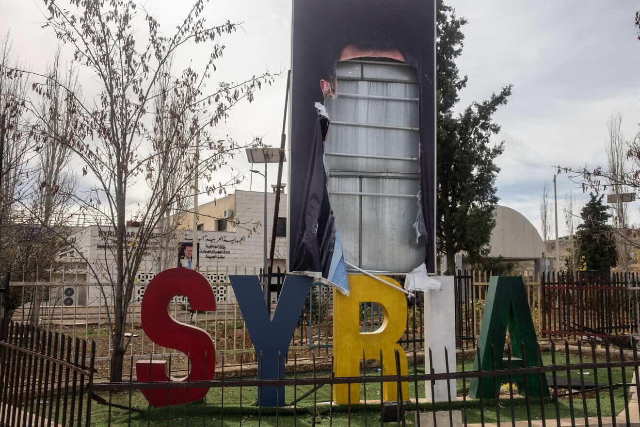 A destroyed poster of former President of Syria Bashar Assad is seen on the side of the highway in Damascus, on Dec. 11, 2024. Photo by Chris McGrath/Getty Images.