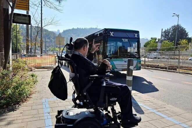 A man in a wheelchair works to bring awareness in Israel about issues of public transportation as part of International Day of Persons with Disabilities on Dec. 3, 2024. Credit: Israel Elwyn.