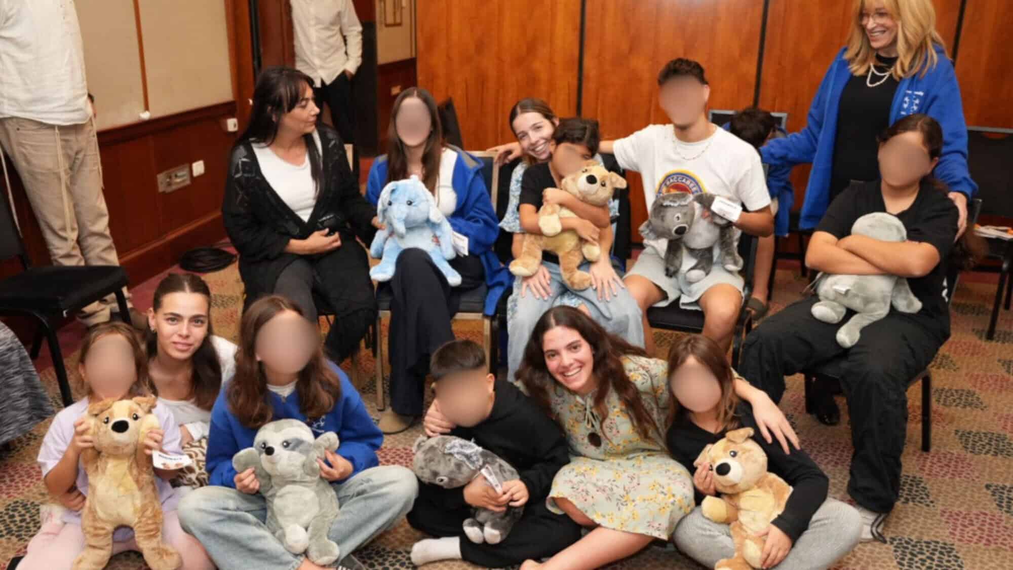 Children who lost both parents since Oct. 7, 2023, with staff and National Service participants at a OneFamily shabbaton in Tel Aviv, December 2024. Photo by Meir Pavlovsky.