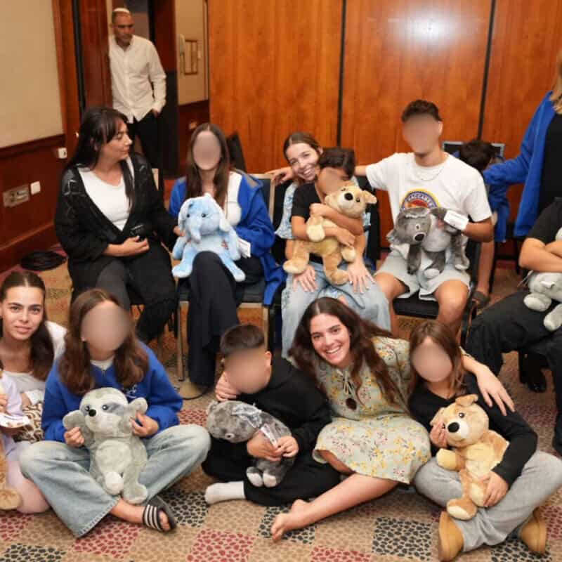 Children who lost both parents since Oct. 7, 2023, with staff and National Service participants at a OneFamily shabbaton in Tel Aviv, December 2024. Photo by Meir Pavlovsky.