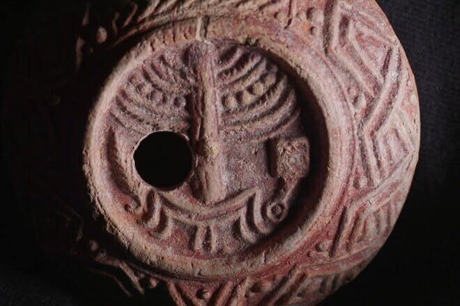 The ancient oil lamp, decorated with a menorah, incense shovel and lulav. Photo by Emil Aladjem/IAA.