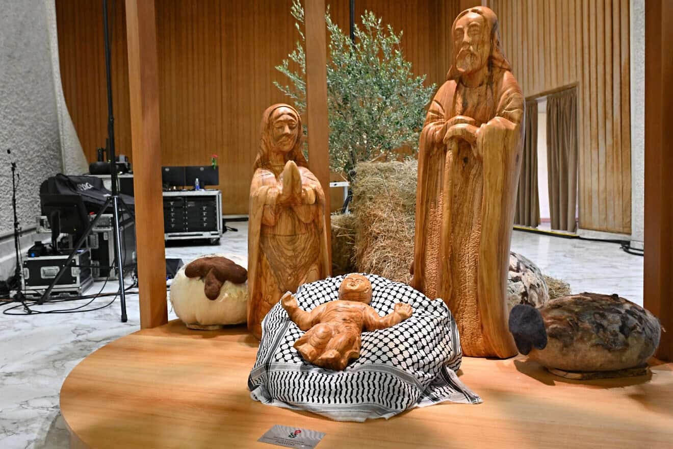 Baby Jesus displayed on a keffiyeh, gifted by the Palestinian Higher Committee of Churches Affairs, as part of the “Nativity of Bethlehem 2024” during its inauguration in the Paul VI Hall, during a private audience to donors of the Nativity Scene and the lighting of the Christmas tree ceremony at St. Peter's Square in the Paul-VI hall at the Vatican on Dec. 7, 2024. Photo by Andreas Solaro/AFP via Getty Images.