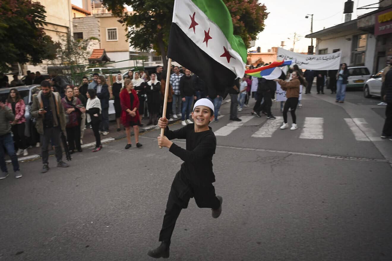 A boy in Majdal Shams, Israel, celebrates with a “Free Syria” flag after rebels take over the regime of Bashar Assad in Syria, Dec. 9, 2024. Photo by Michael Giladi/Flash90.