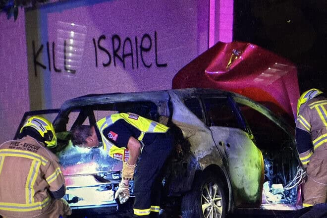 Police examine a car torched in front of a home in Woolhara, Australia on Dec. 10, 2024. Photo courtesy of Alex Ryvchin.