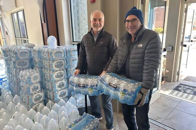 Steve Marks and Quentin Kidd drop off cases of water at the UJCVP Campus in Newport News, Va., January 2025. Credit: Courtesy.