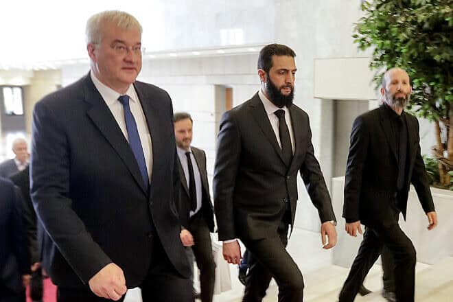 Ukraine's Foreign Minister Andrii Sybiha (left) leads a delegation as they are received by Syrian leader Ahmed al-Sharaa (center) in Damascus, on Dec. 30, 2024. Photo by Bakr Alkasem/AFP via Getty Images.