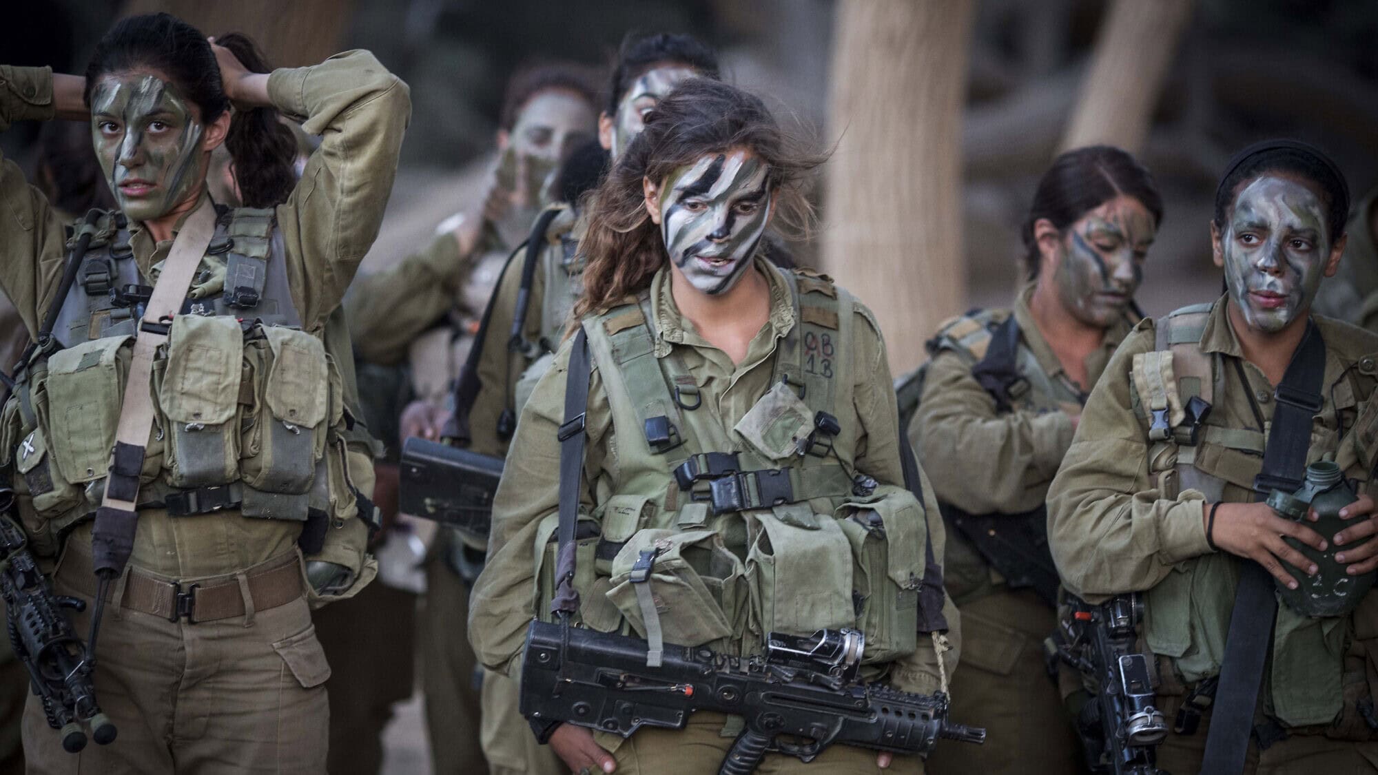Soldiers of the IDF's mixed gender Caracal Infantry Battalion prepare for a 9.5-mile overnight hike to complete their training course, near the border with Egypt, on Sept. 3, 2014. Photo by Hadas Parush/Flash90.
