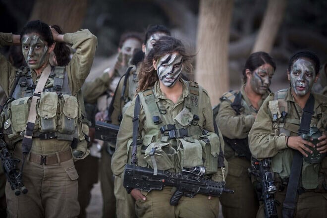 Soldiers of the IDF's mixed gender Caracal Infantry Battalion prepare for a 9.5-mile overnight hike to complete their training course, near the border with Egypt, on Sept. 3, 2014. Photo by Hadas Parush/Flash90.
