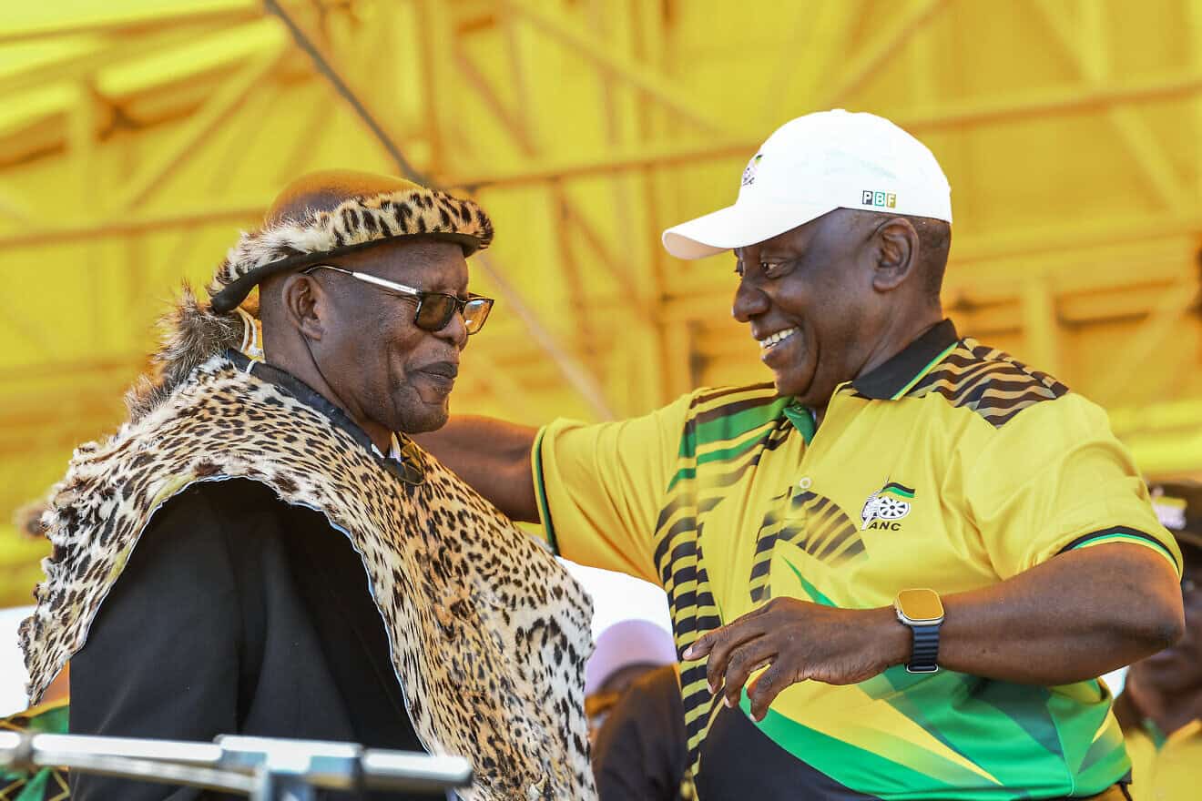 South African and African National Congress President  Cyril Ramaphosa (right) presents an honorary leopard skin to veteran ANC member Benson Fihla during the party's 113th anniversary celebrations at a large open field in the Khayelitsha area of Cape Town on Jan. 11, 2025. Photo by Rodger Bosch/AFP via Getty Images.