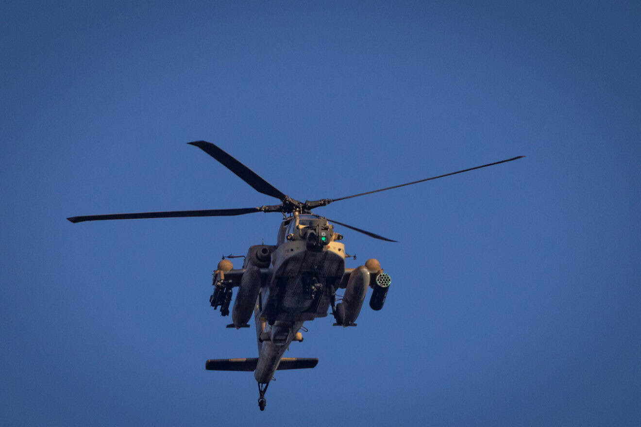 An Israeli military helicopter fly above Kiryat Yam, near Haifa, Nov. 13, 2024. Photo by Yonatan Sindel/Flash90.