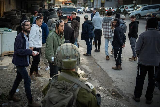 Jews pray at the scene where three Israelis were murdered in a shooting attack, in the village of al-Funduq in Samaria, Jan. 6, 2025. Photo by Erik Marmor/Flash90.
