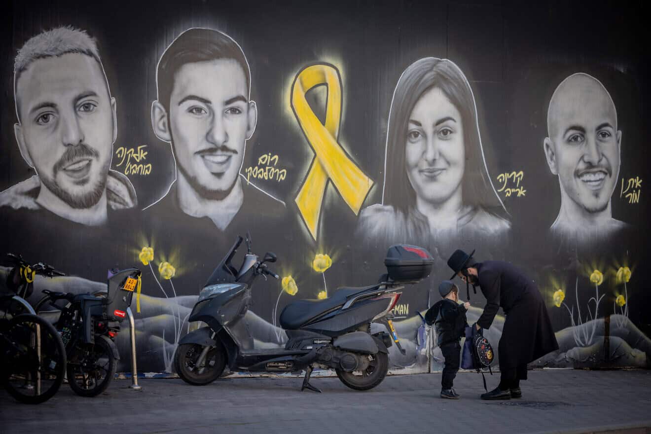 People walking next to pictures of Israelis held hostage by Hamas terrorists in Gaza, in Jerusalem, Jan. 13, 2025. Photo by Chaim Goldberg/Flash90.