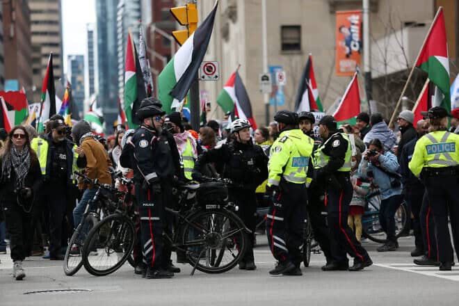 Police officers keep watch over a situation during a demonstration march on April 21, 2024 in Toronto, Ontario. Photo by Maryam Majd/Getty Images.