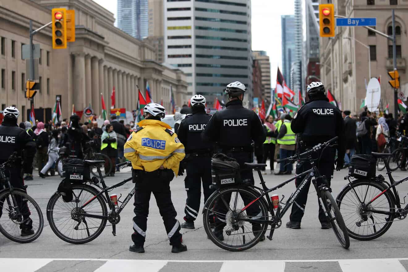 Police officers keep watch over a situation during a demonstration march on April 21, 2024 in Toronto, Ontario. Protesters demanded a ceasefire in the current conflict in the Gaza Strip. Photo by Maryam Majd/Getty Images.