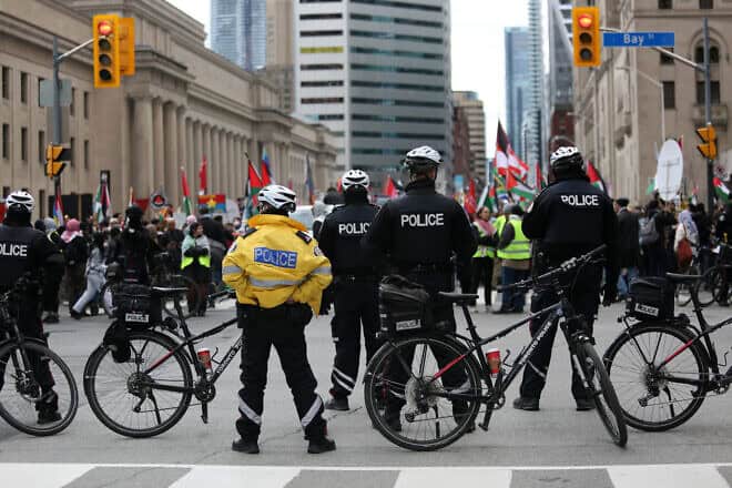 Police officers keep watch over a situation during a demonstration march on April 21, 2024 in Toronto, Ontario. Protesters demanded a ceasefire in the current conflict in the Gaza Strip. Photo by Maryam Majd/Getty Images.