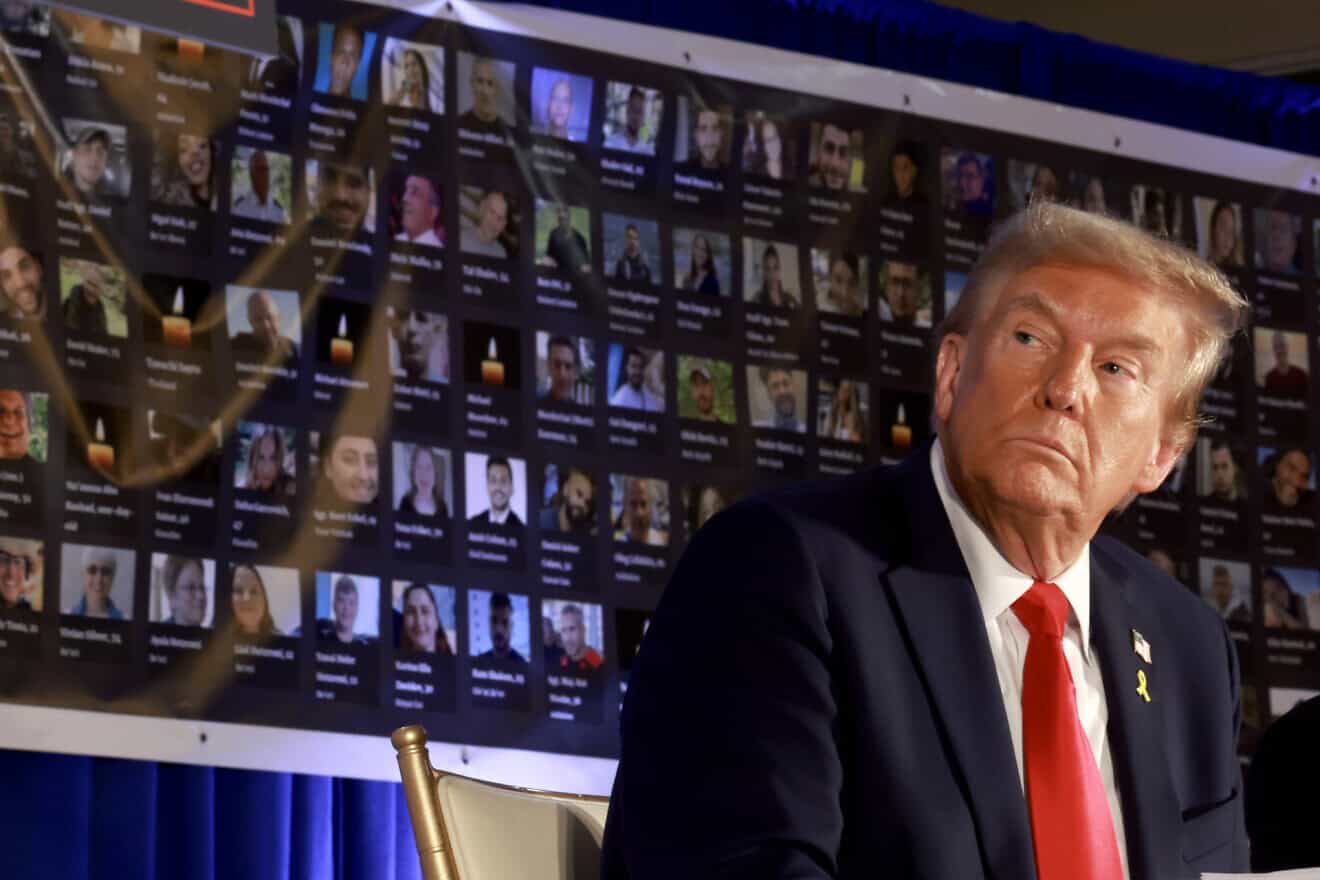 Pictures of hostages and victims are seen by then-Republican presidential candidate and former president Donald Trump during a remembrance event to mark the first anniversary of the Hamas attack on Israel at Trump National Doral golf club in Miami, on Oct. 7, 2024. Photo by Joe Raedle/Getty Images.