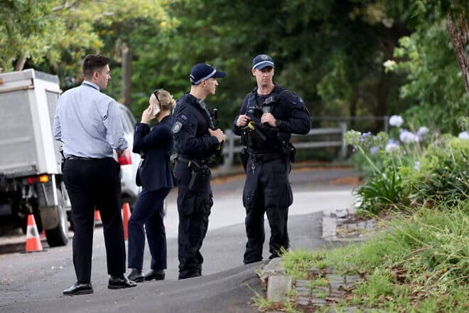 Police officers and detectives inspect the area where anti-Israel graffiti was written on a wall in the Sydney suburb of Woollahra on Dec. 11, 2024. Photo by David Gray/AFP via Getty Images.