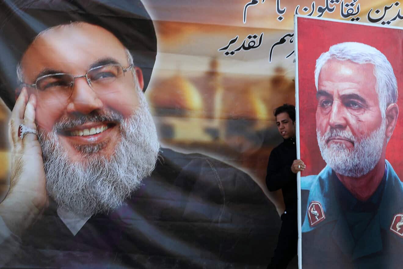 Posters of slain Hezbollah leader Hassan Nasrallah (left) and slain Iranian Revolutionary Guard Corps Quds Force commander Qassem Soleimani at a rally in the Shula area, west of Baghdad, on Jan. 1, 2025, Photo by Ahmad al-Rubaye/AFP via Getty Images.