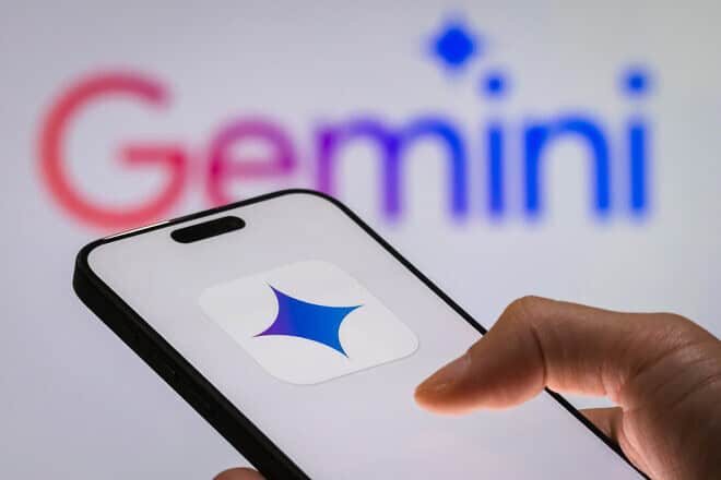 In this photo illustration, a person holds a smartphone displaying the logo of “Gemini,” Google’s AI model, with the “Gemini” logo visible in the background, reflecting the advancements in generative AI technologies and their growing role in innovation in Chongqing, China, on Dec. 29, 2024. Photo illustration by Cheng Xin/Getty Images.