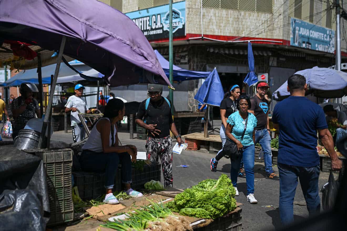 People walk through the street market at the Perez Bonalde square in the Catia neighborhood in Caracas on Jan. 6, 2025. Photo by Federico Parra/AFP via Getty Images.