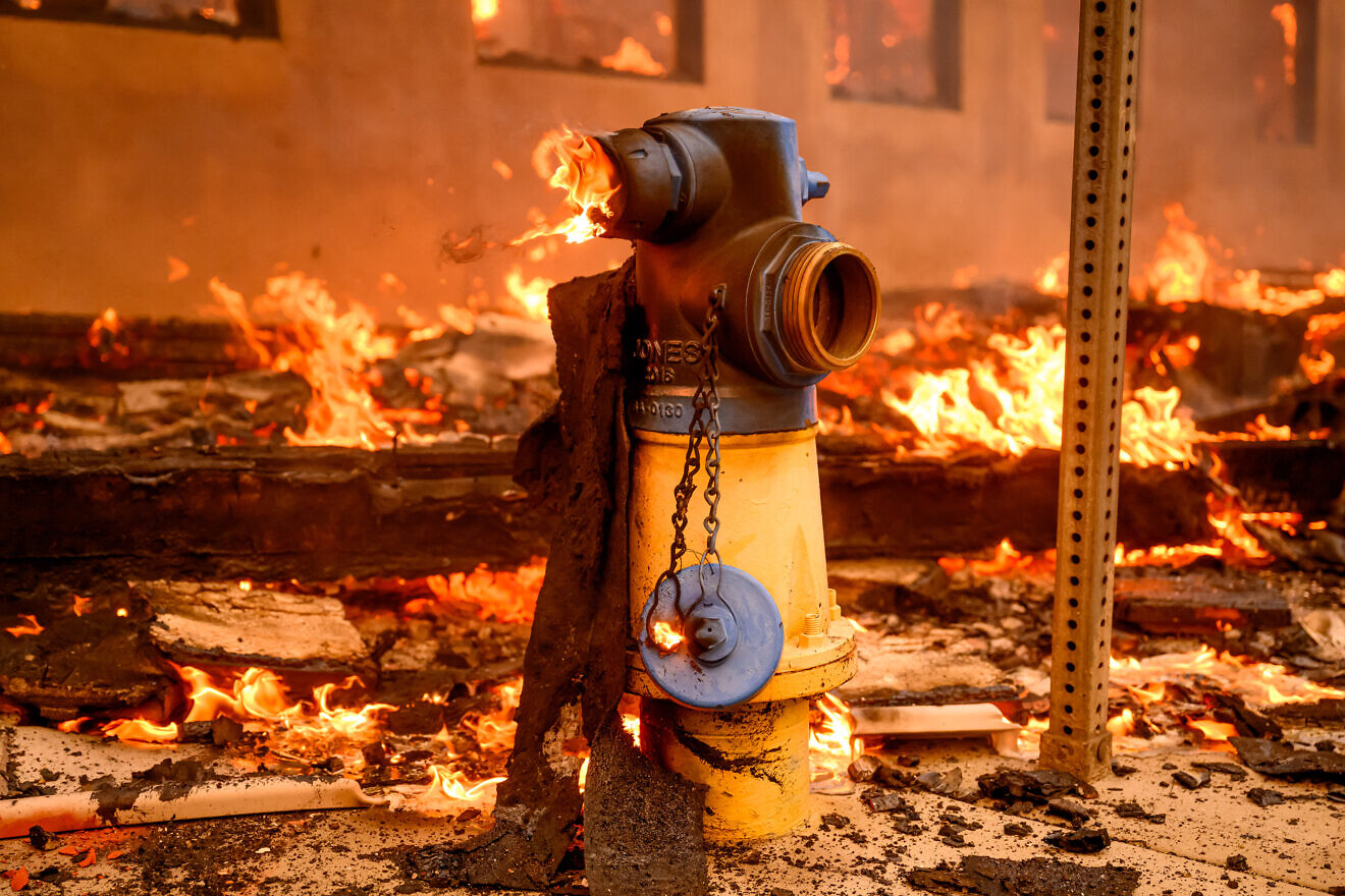 A fire hydrant burns during the Eaton fire in the Altadena area of Los Angeles county, Calif. on Jan. 8, 2025. Credit: Josh Edelson/AFP via Getty Images.