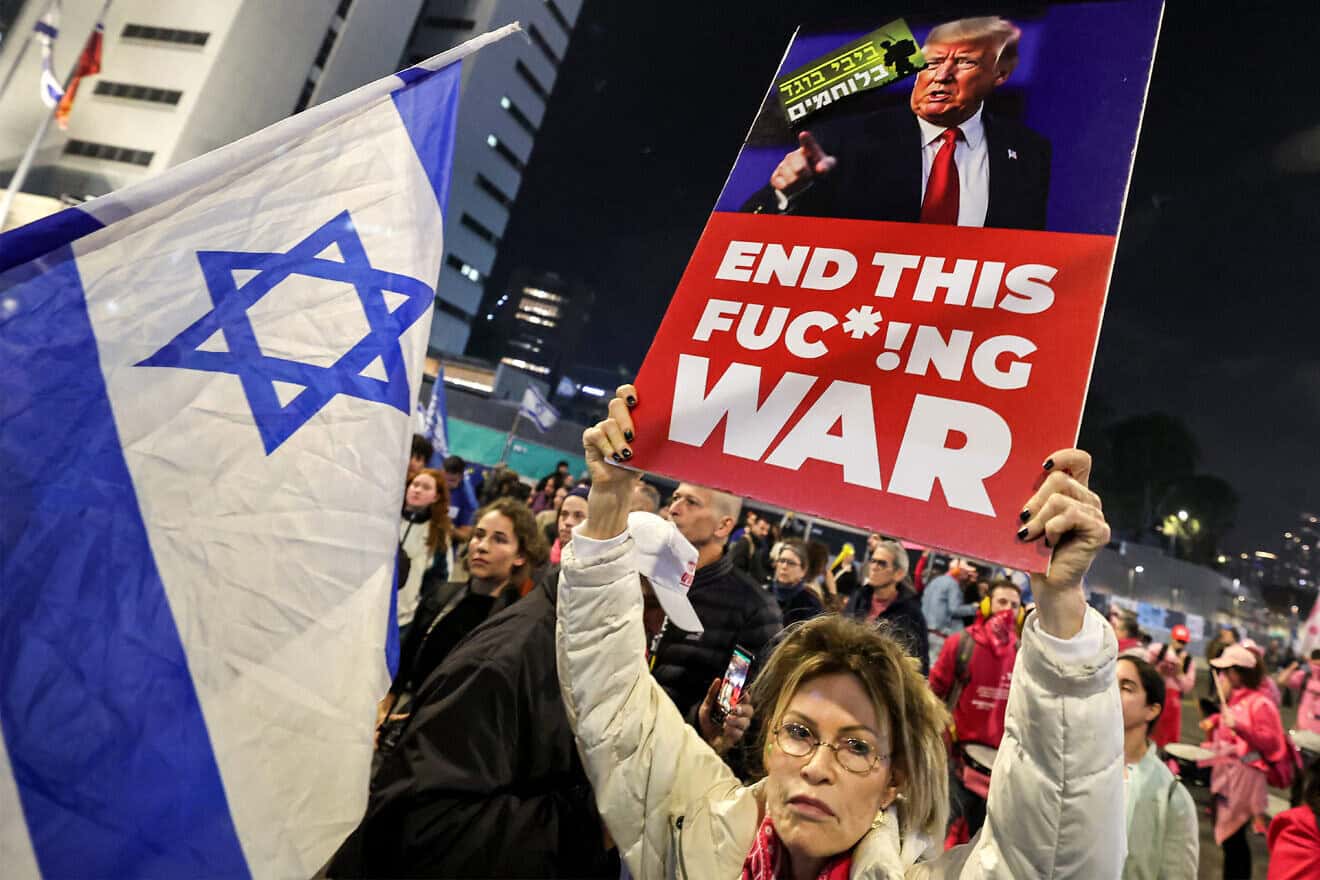 A demonstrator holds a sign calling upon US President-elect Donald Trump to intervene during an anti-government protest calling for action to secure the release of Israelis held hostage in Gaza since October 2023, outside the Israeli Defence Ministry headquarters in Tel Aviv on Jan. 11, 2025, amid the ongoing war in the Palestinian territory between Israel and Hamas. Photo by Jack Guez/AFP via Getty Images.