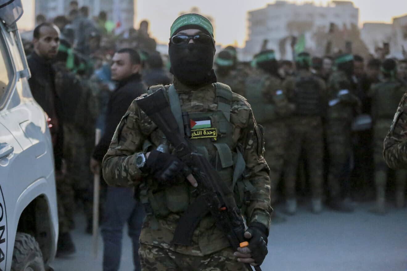 Hamas terrorists escort a Red Cross vehicle to collect Israeli hostages released after a ceasefire agreement between Israel and Hamas took effect, in Gaza City on Sunday, Jan. 19, 2025. Photo by Abood Abusalama/Middle East Images/AFP via Getty Images.