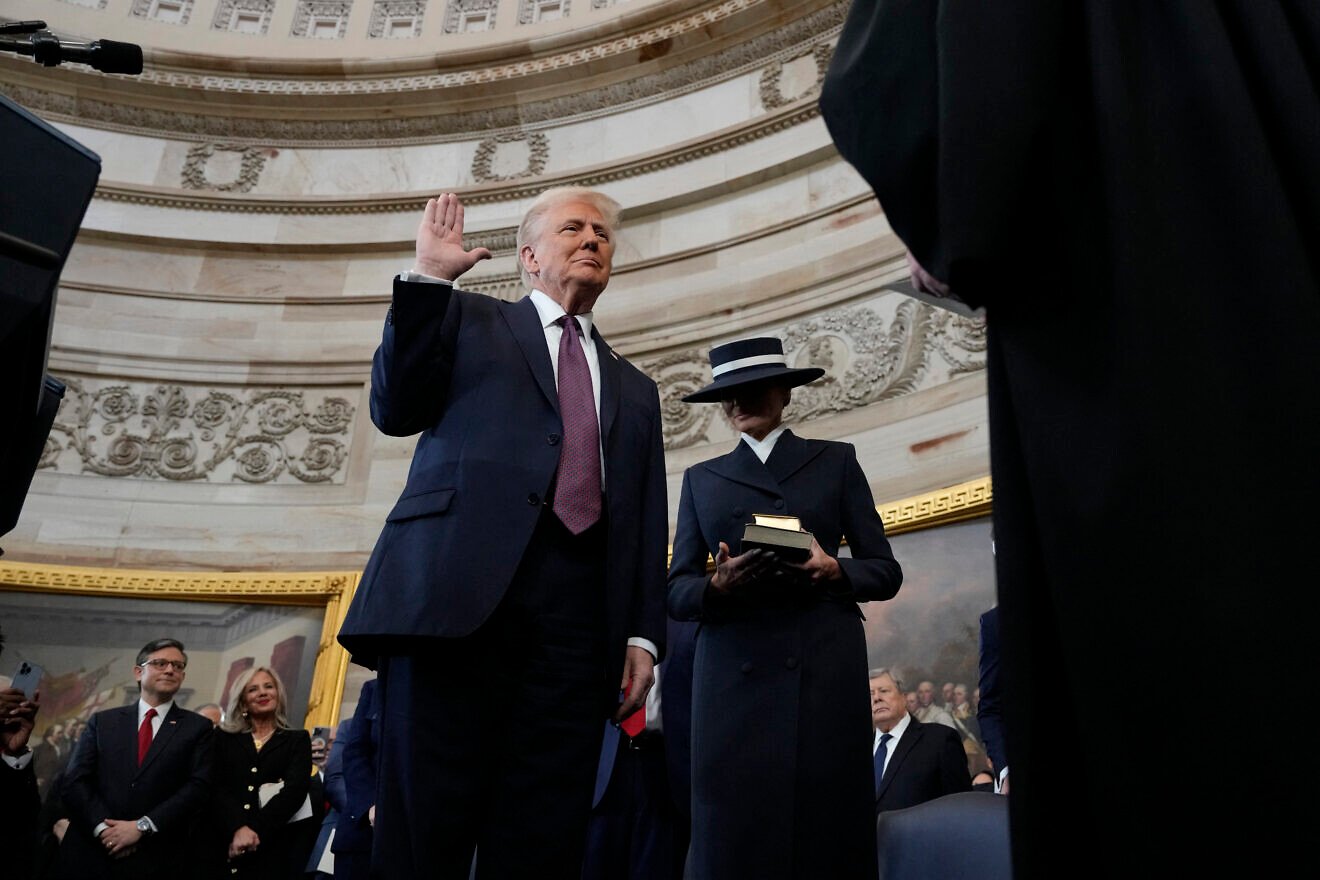U.S/ President-elect Donald Trump takes the oath of office as Melania Trump looks on during inauguration ceremonies in the Rotunda of the U.S. Capitol, Jan. 20, 2025 in Washington, D.C. Credit: Morry Gash/Pool/AFP.