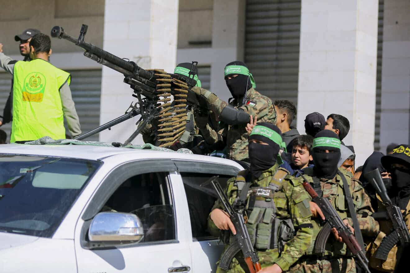 Hamas terrorists before releasing four Israeli hostages to a Red Cross team in Gaza City, January 25, 2025. Photo by Aboos Abusalama/Middle East Images/AFP via Getty Images.