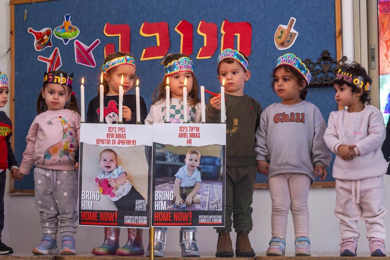 Children light Chanukah candles and bring attention to Kfir and Ariel Bibas, the youngest hostages who have been held by Hamas in Gaza since the terrorist attacks in southern Israel on Oct. 7, 2023, at a kindergarten in Moshav Yashresh in central Israel, Dec. 12, 2023. Photo by Yossi Aloni/Flash90.