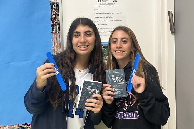 The students Ava Bienenfeld and Abby Adler of Katz Hillel Day School in Boca Raton, Fla., hold their All Mishnah Jr. Mishnayot and slap bracelets. Credit: Orthodox Union.